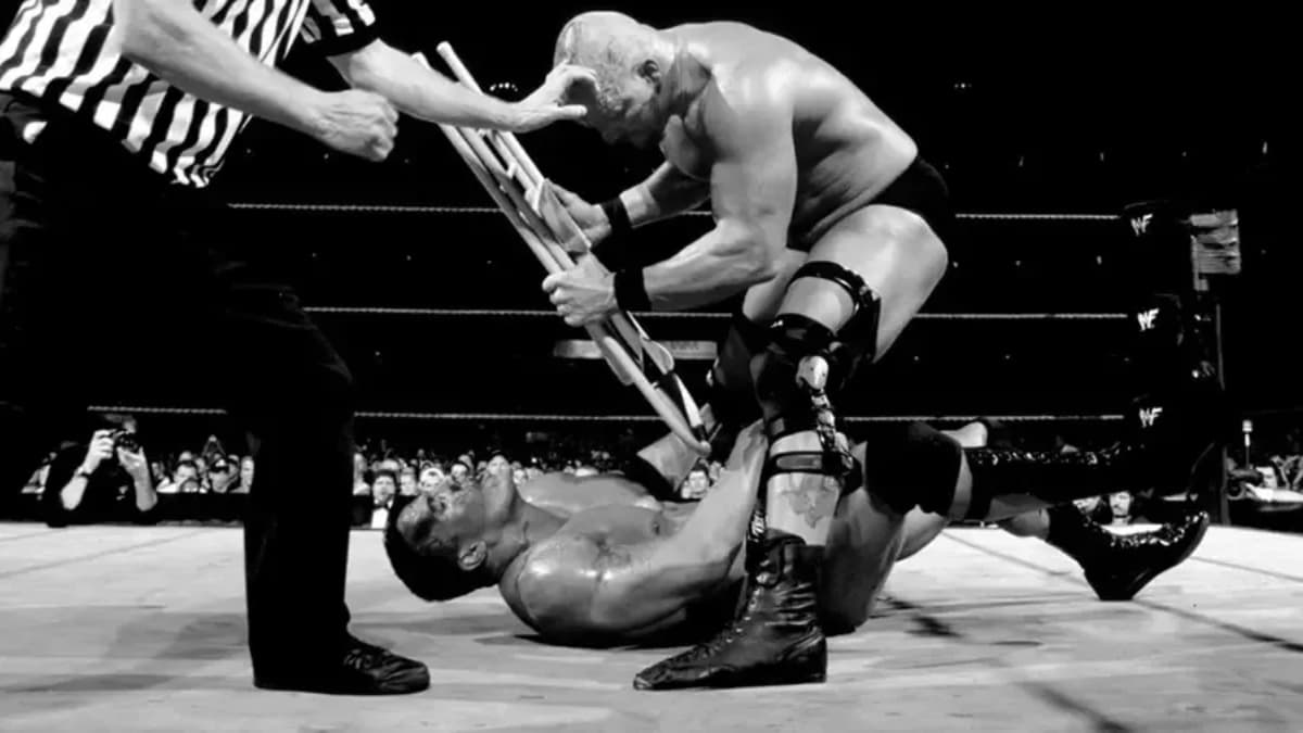 Steve Austin hitting The Rock with a steel chair at WWE WrestleMania X-Seven