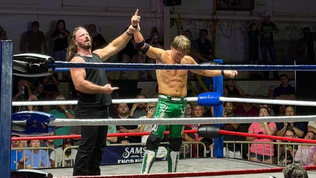 Avery Styles having his arm raised by AJ Styles