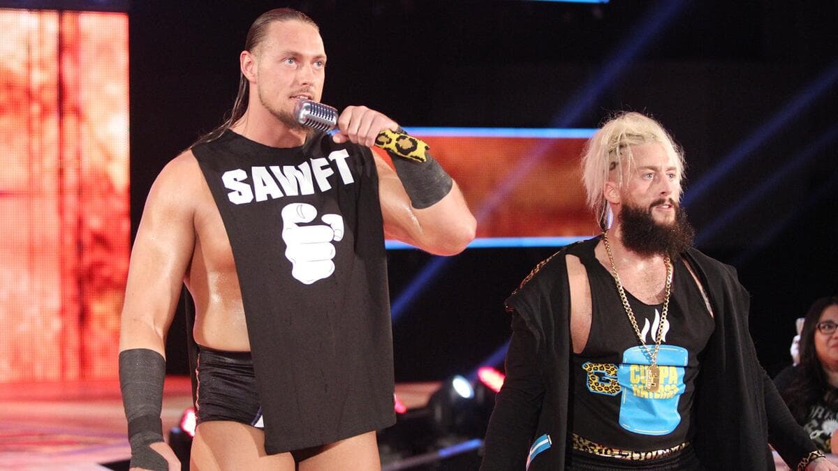Big Cass holding a microphone standing alongside Enzo Amore
