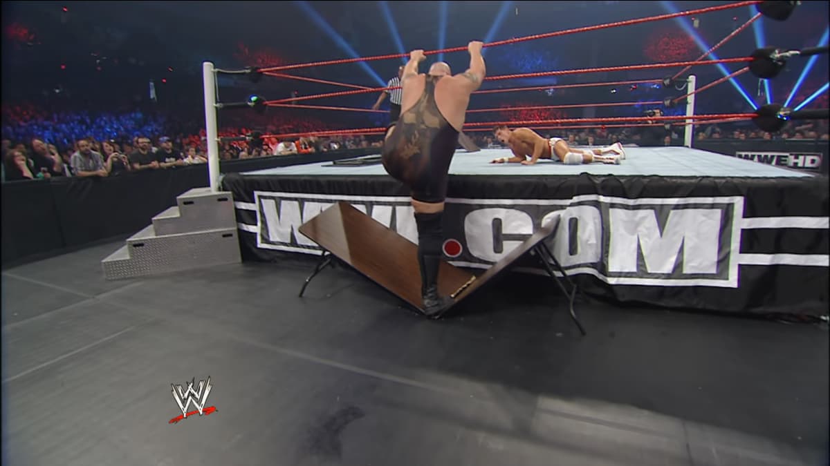 Big Show/Paul Wight with his foot through the table at WWE Extreme Rules 2012