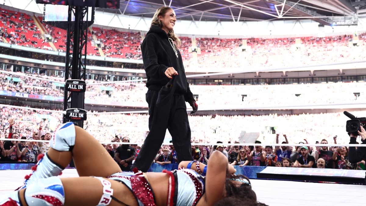 Britt Baker standing next to a down Maya World at AEW All In 2026