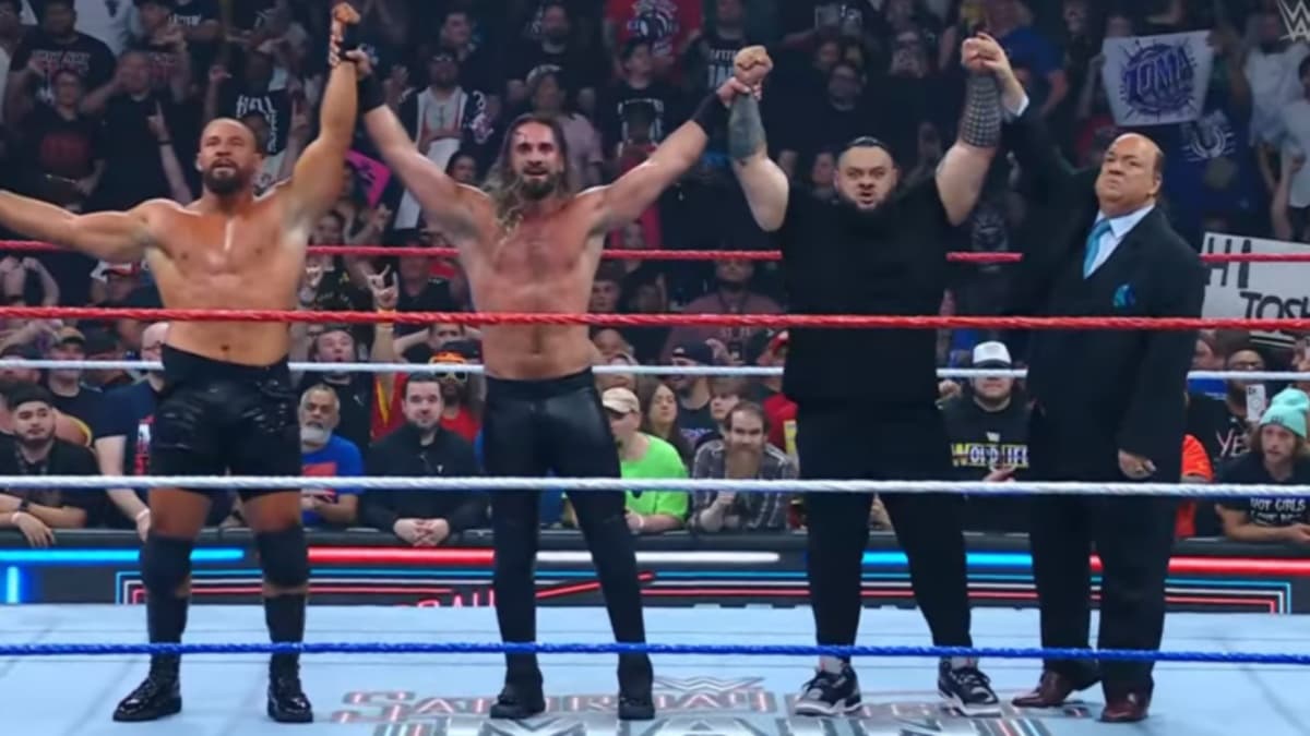 Bronson Reed, Seth Rollins and Bron Breakker holding their hands in the air together 