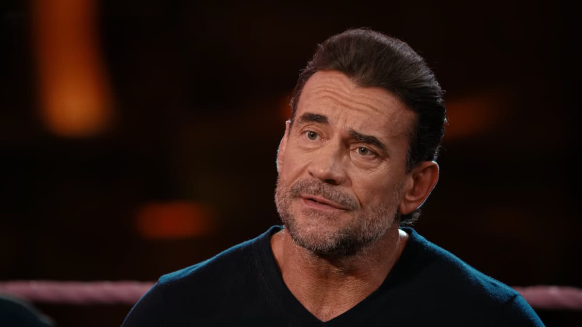 CM Punk looking concerned in a black sweater on Hot Ones