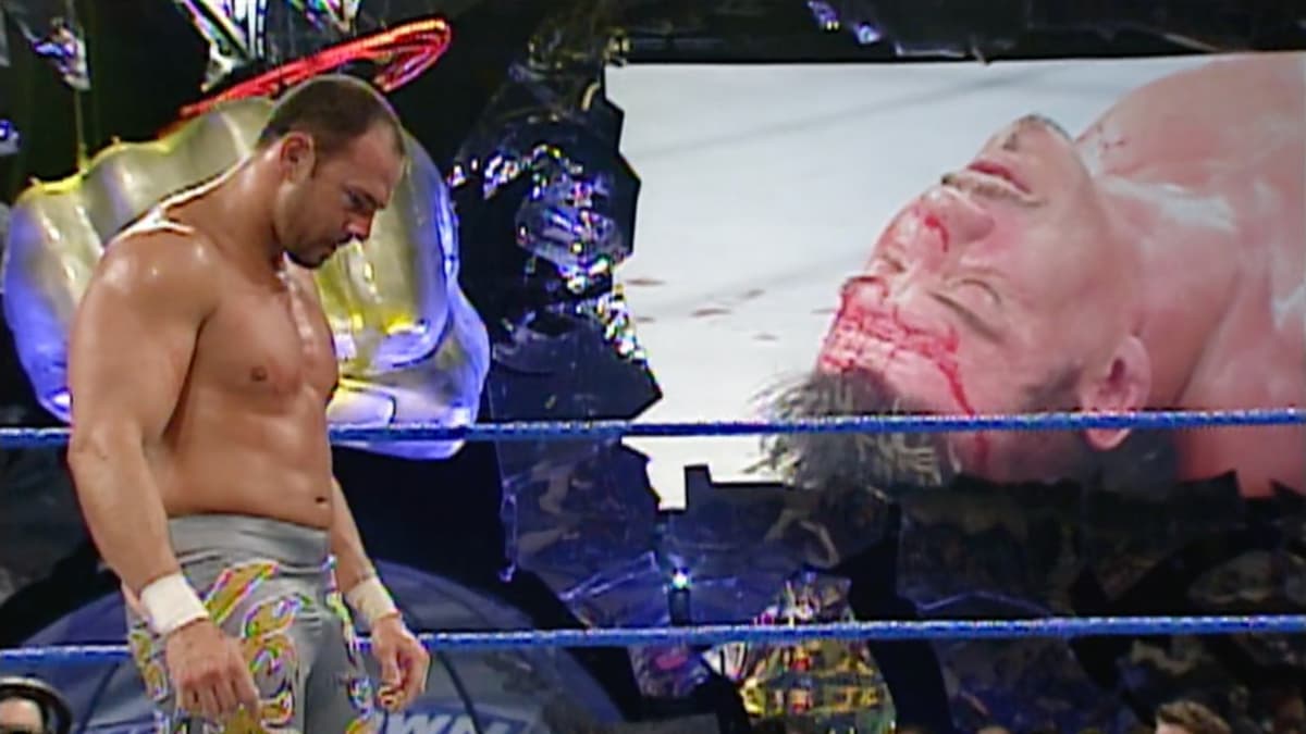 Chavo Guerrero looking down as Eddie Guerrero is lay down on the titantron