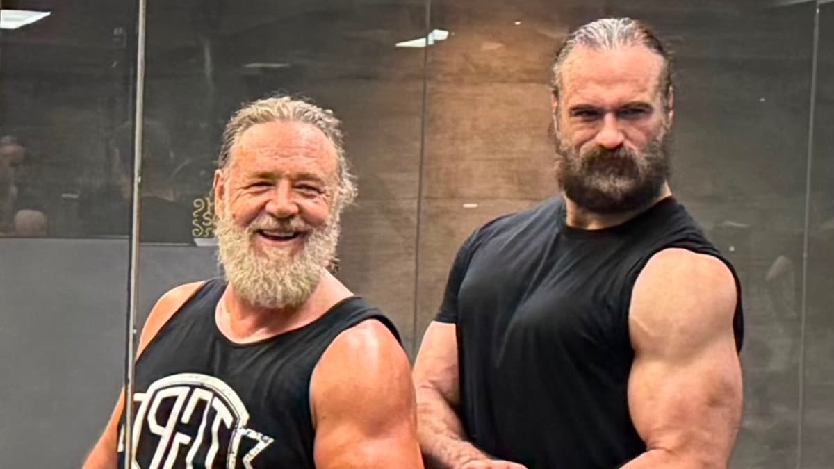 Drew McIntyre and Russell Crowe flexing in the gym mirror together