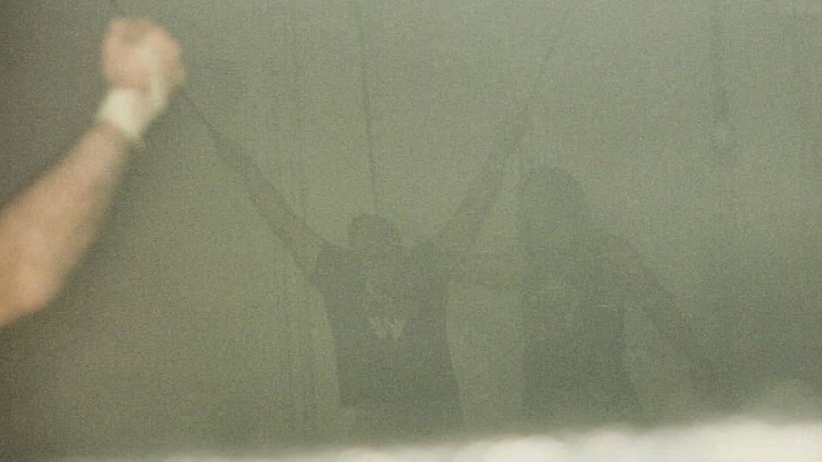 Raven stood next to Tommy Dreamer in a mock cruxifixction as the air is full or smoke 
