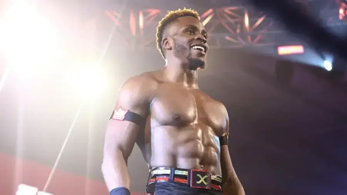 Edris Enofe smiling and looking out at a crowd (off camera)