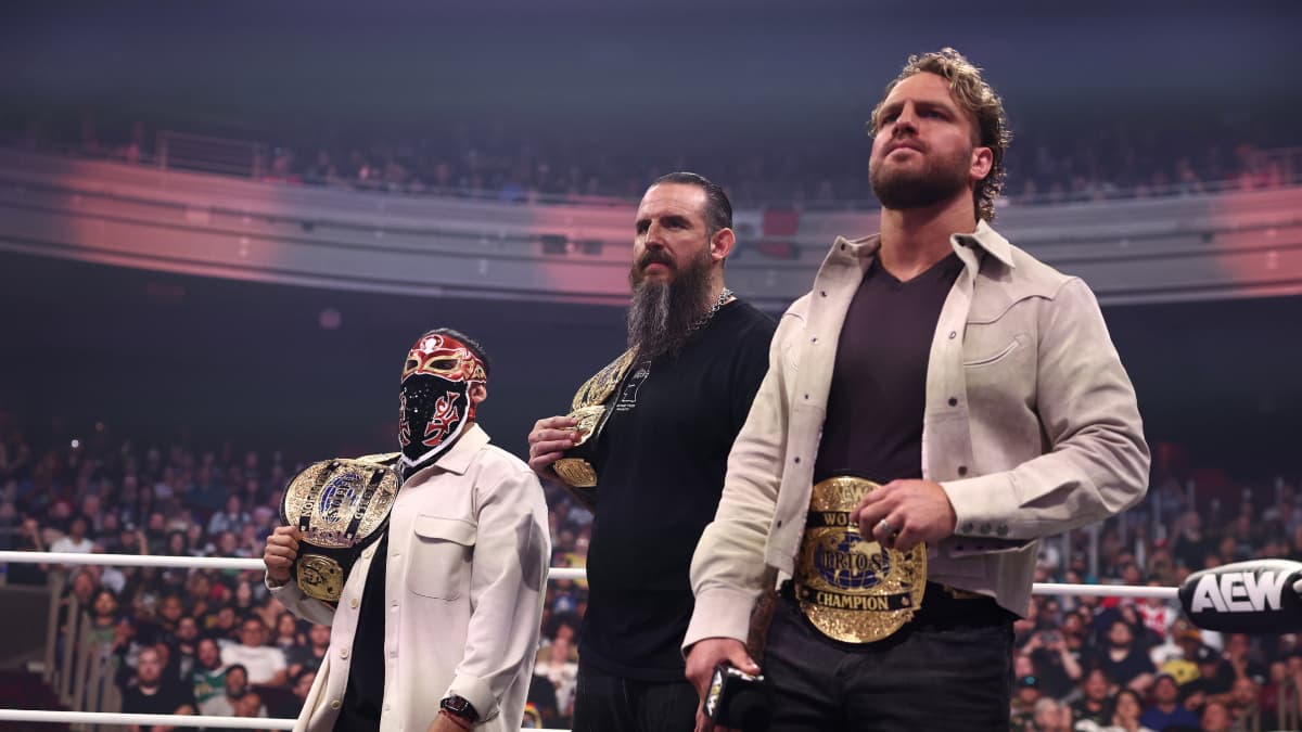Hangman Page and Brodido in the ring with the AEW World Trios Title