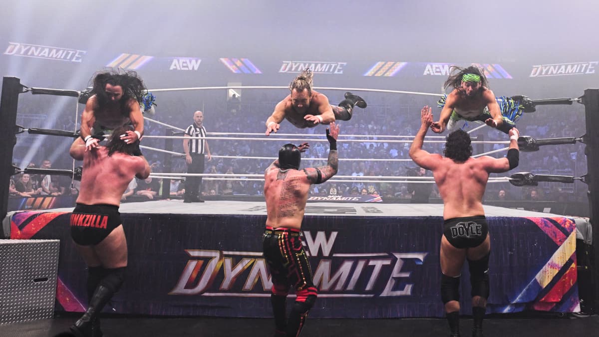 Kenny Omega and The Young Bucks hitting suicide dives on AEW Dynamite