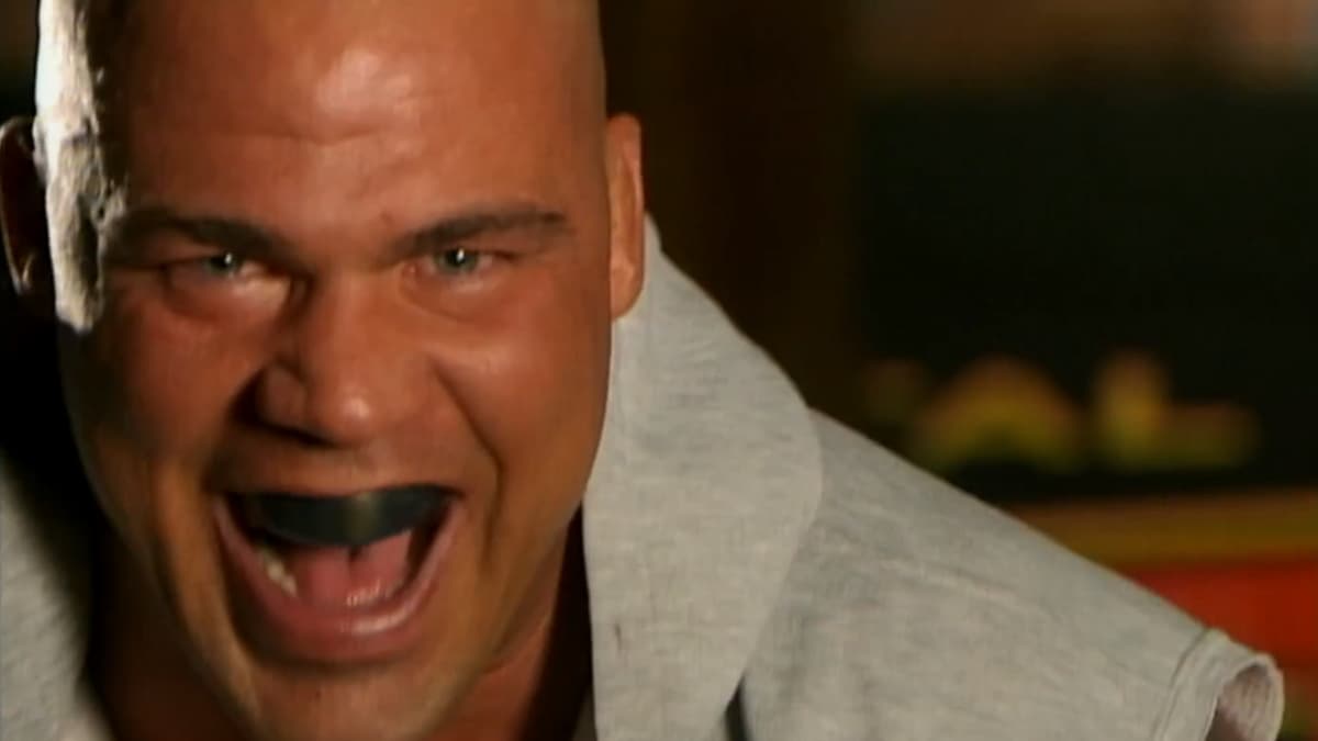 Kurt Angle laughing like a maniac with a white towel around his neck