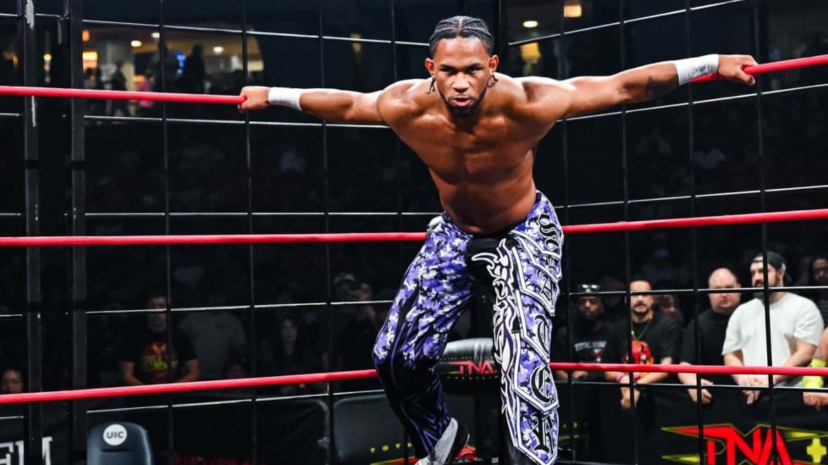 Leon Slater with his hands on the rope inside the cage at TNA Lockdown 2026