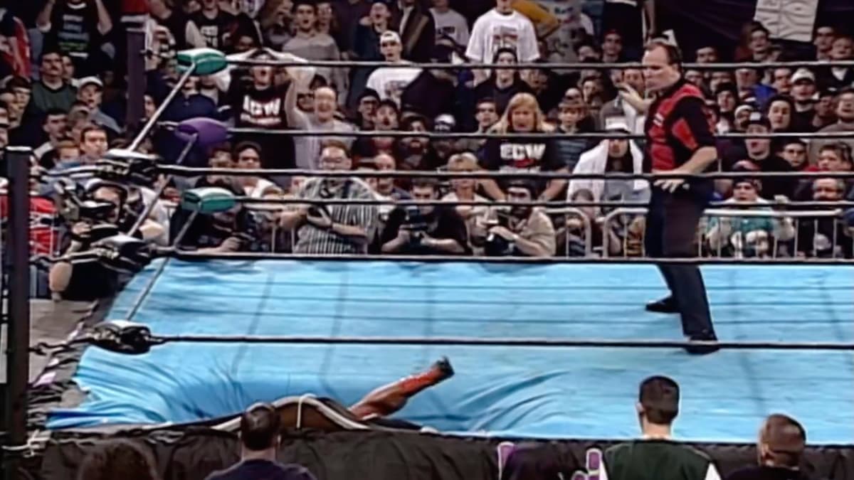Bam Bam Bigelow and Taz lying inside the ring at ECW Living Dangerously 1998