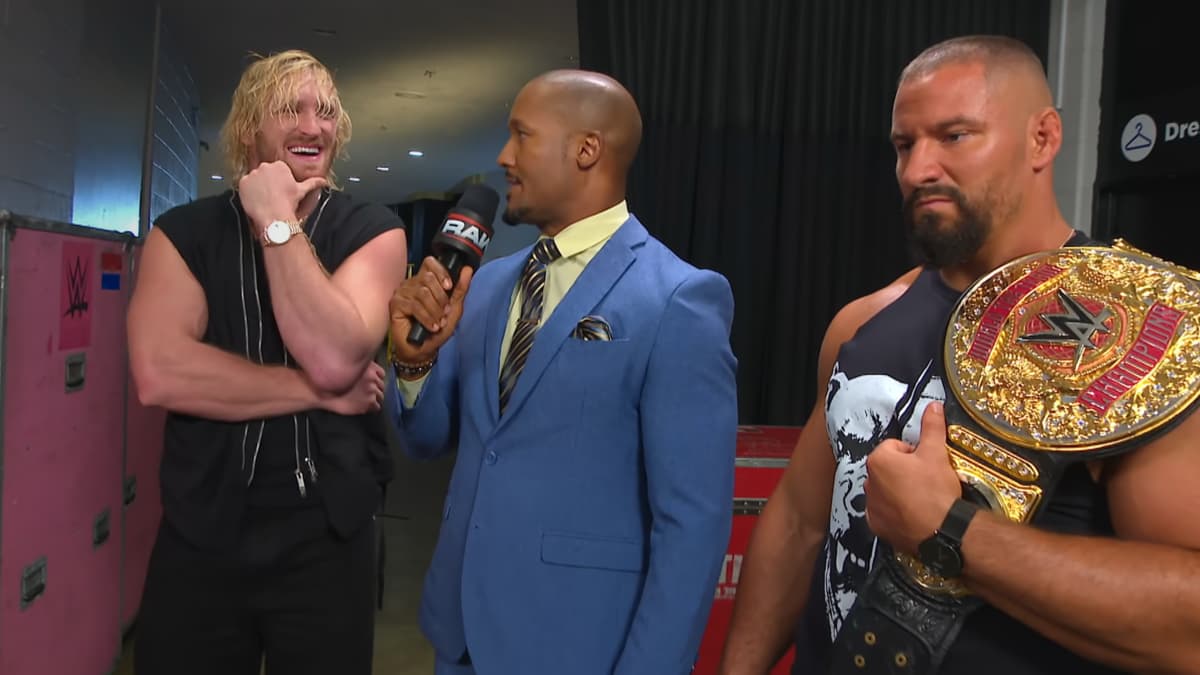 Logan Paul being interviewed by Byron Saxton while Logan Paul stands there annoyed