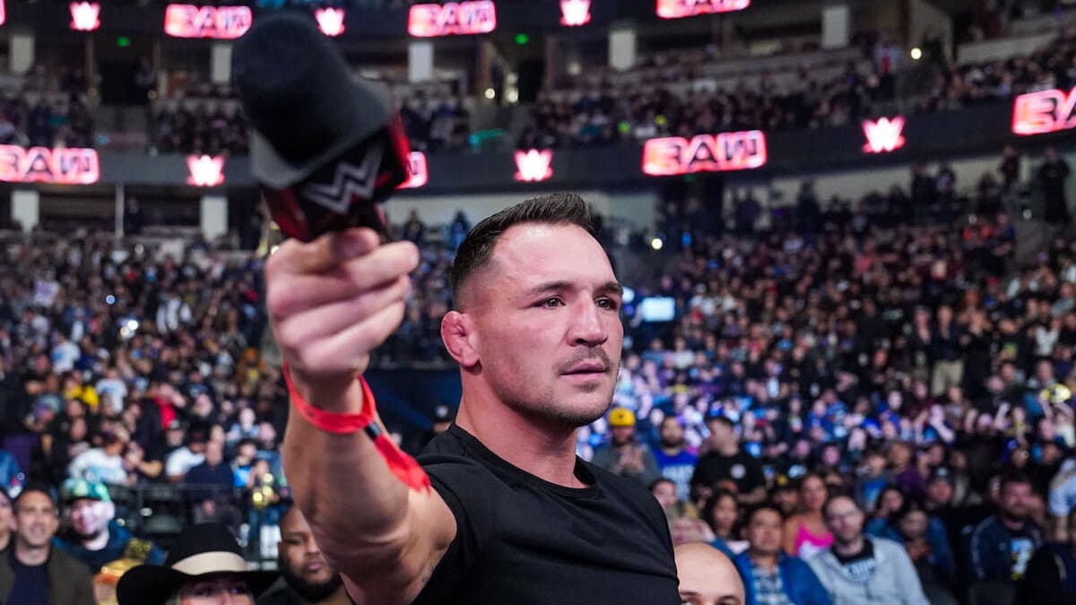 Michael Chandler holding up a microphone on WWE Raw