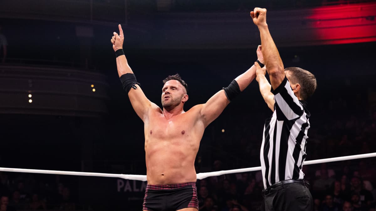 Nigel McGuinness with his hand raised on AEW Collision 