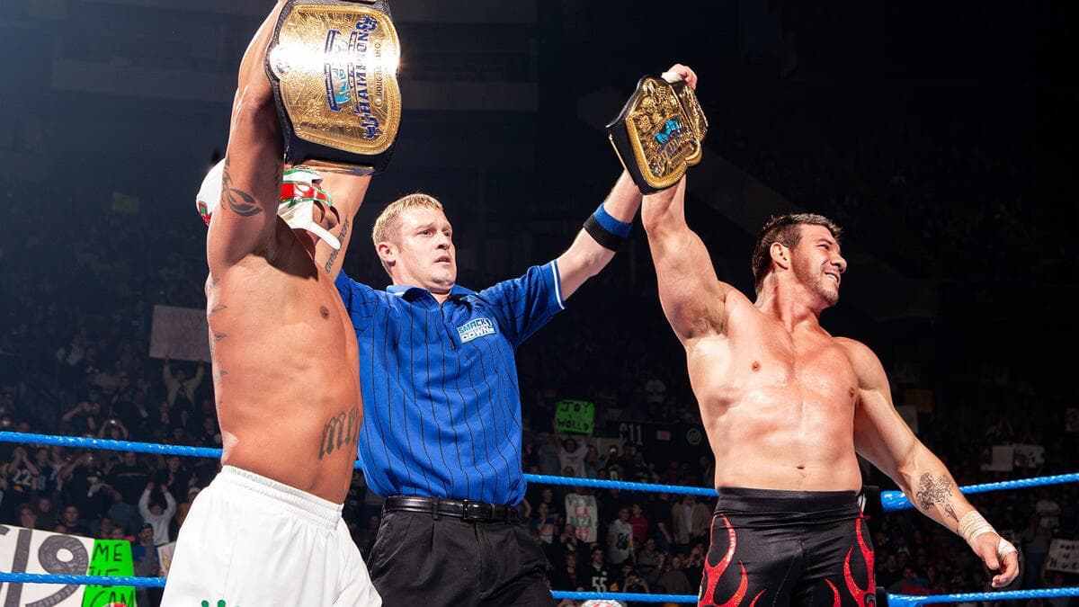 Rey Mysterio and Eddie Guerrero holding up the WWE Tag Team Titles
