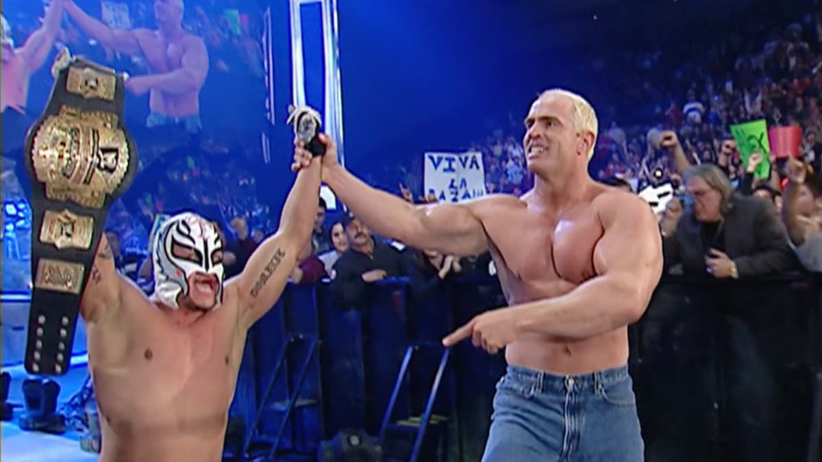 Rey Mysterio having his arm raised by Hardcore Holly
