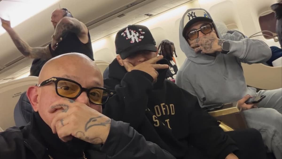 Rey Mysterio, Penta and Dragon Lee covering their faces