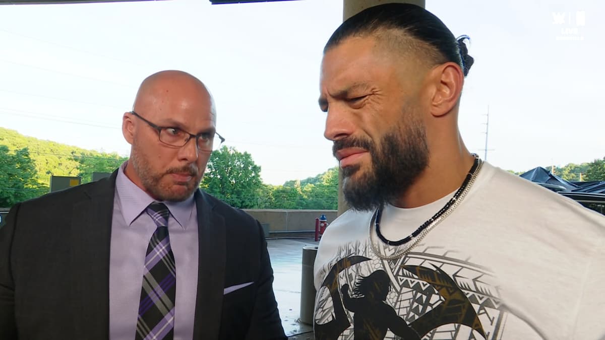 Roman Reigns looking annoyed at Adam Pearce on WWE Raw