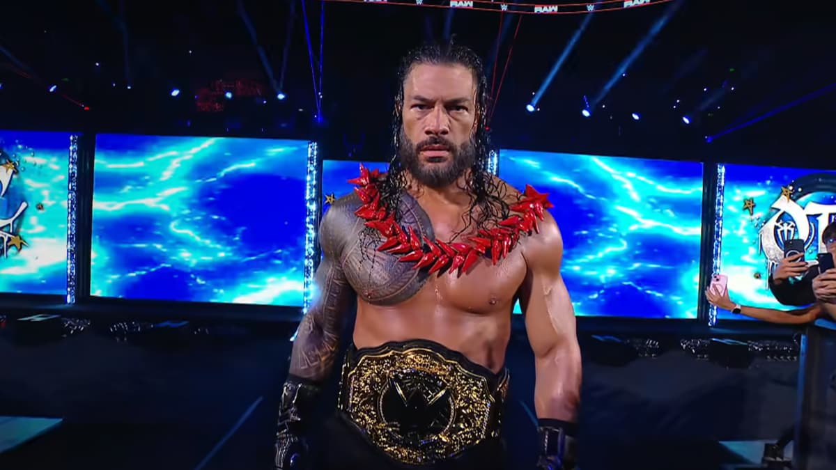 Roman Reigns making his way to the ring with the ula fala and WWE World Heavyweight Title