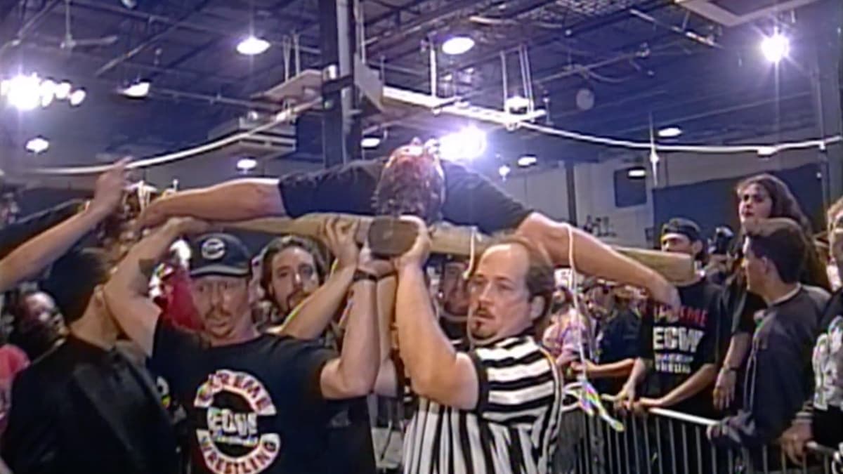 Sandman on a cross being carried to the back at ECW High Incident