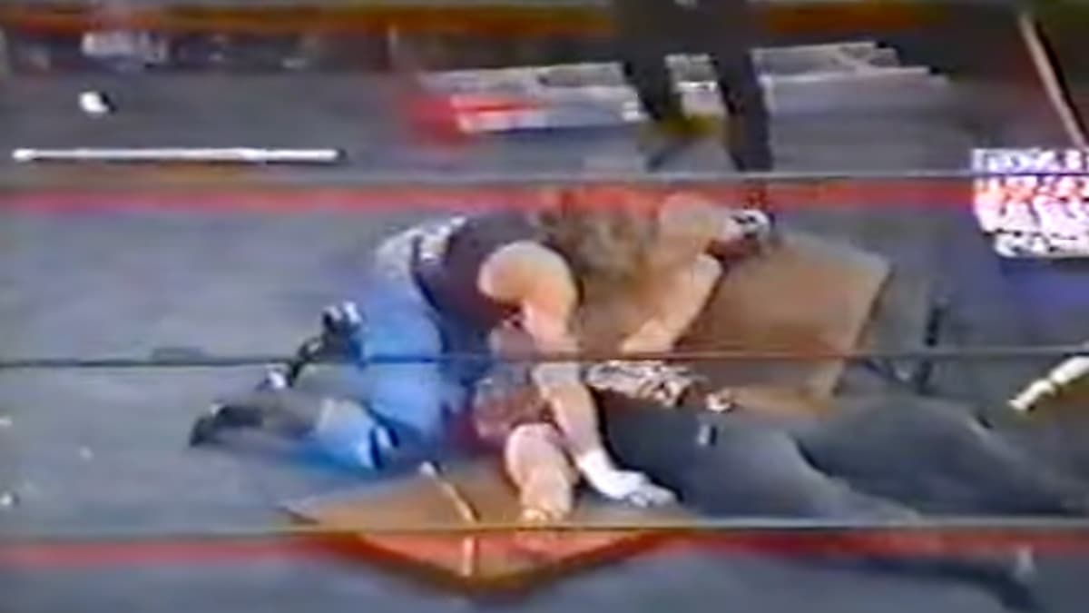 Shawn Michaels putting Venom through the table