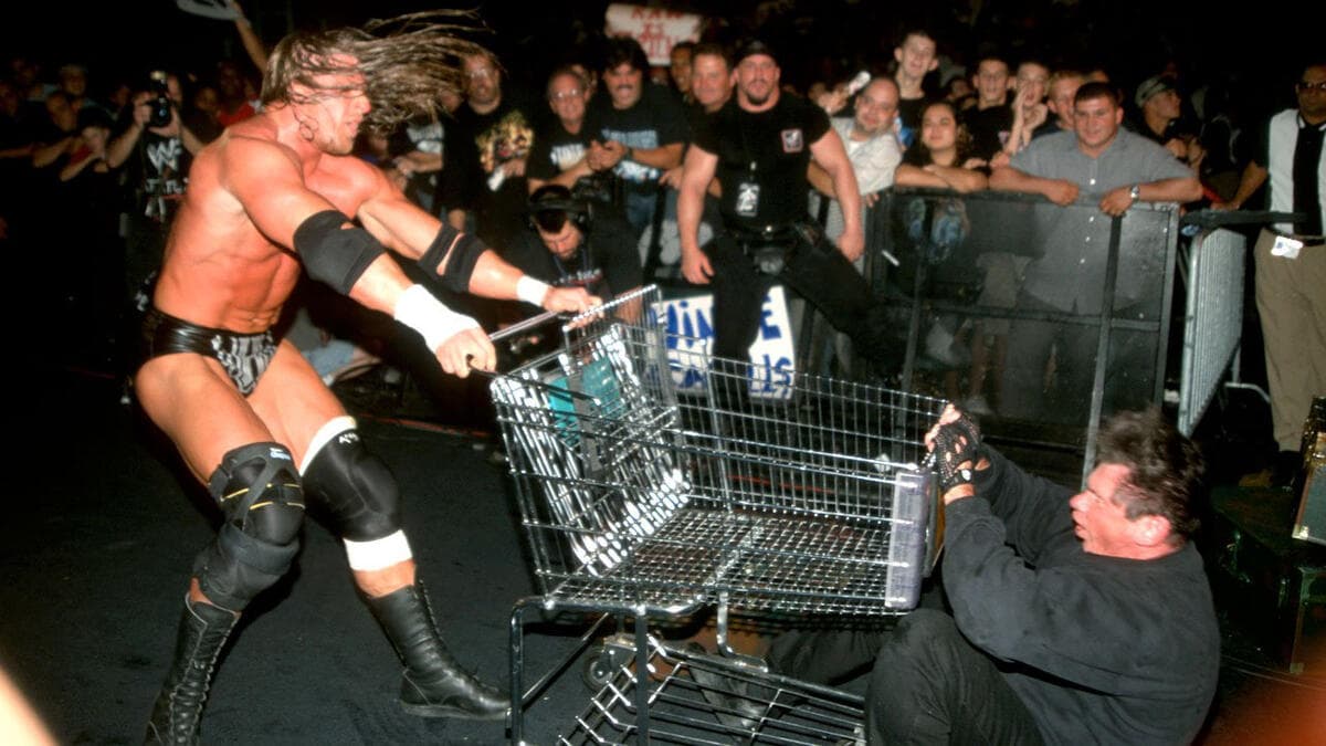 Triple H rams a shopping trolley/cart into a downed Vince McMahon in front of an audience.