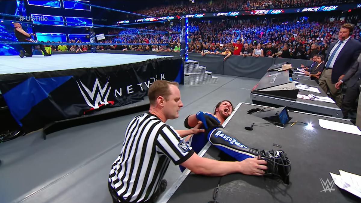 AJ Styles having his foot freed by the referee at WWE Backlash 2017