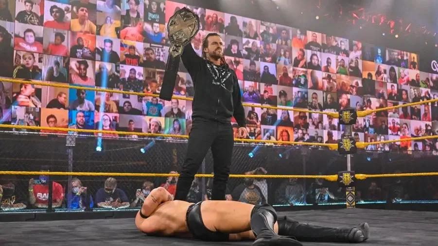 Adam Cole NXT Title aloft.jpg