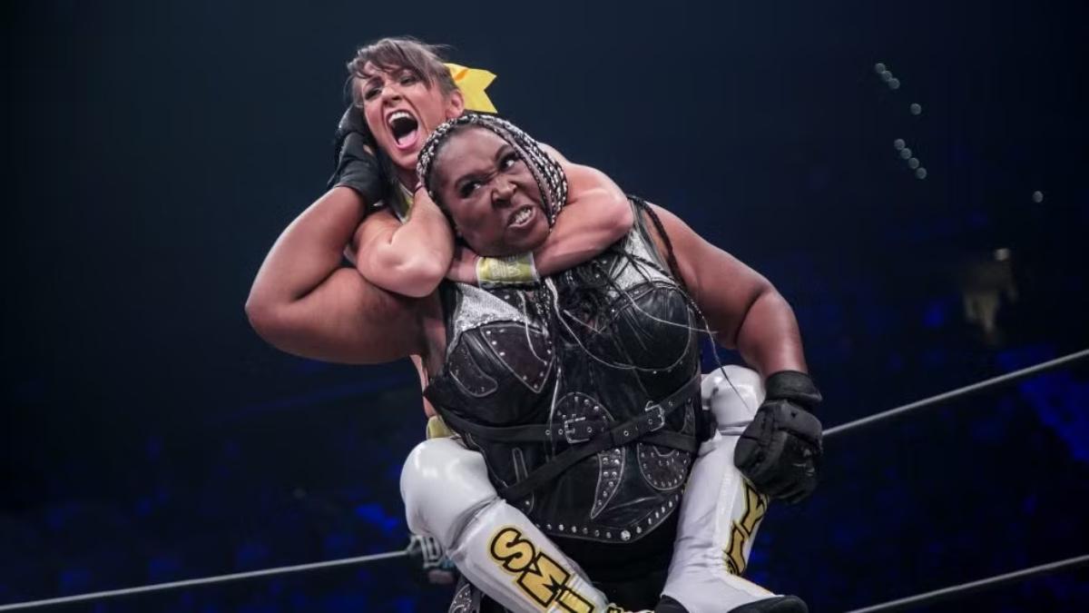 Awesome Kong wrestles Kylie Rae, who has her opponent locked in a sleeper hold