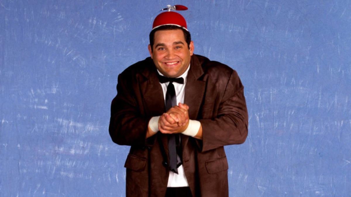 Beaver Cleavage wearing a brown suit and red propeller hat