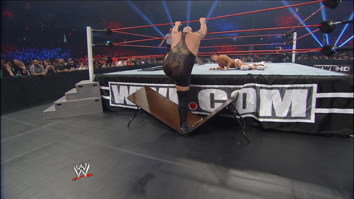 Big Show/Paul Wight with his foot through the table at WWE Extreme Rules 2012