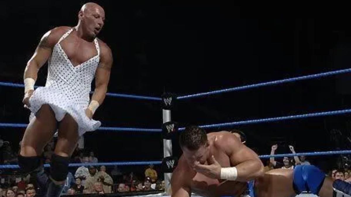 Big Vito dancing in a white dress in a WWE ring