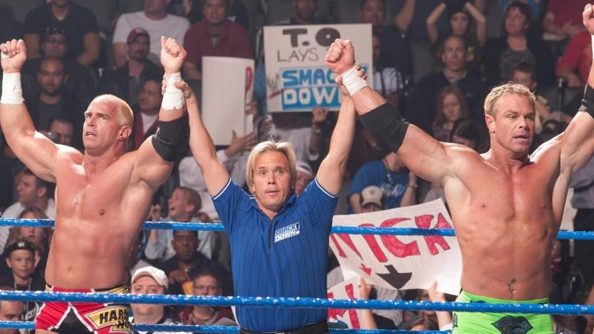 Billy Gunn and Hardcore Holly with their arms raised by referee Charles Robinson