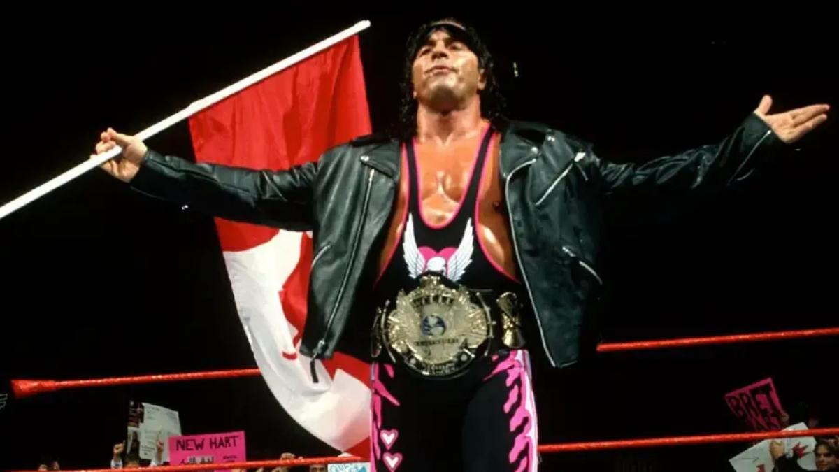 Bret Hart with WWE Title in front of a Canada flag in 1997