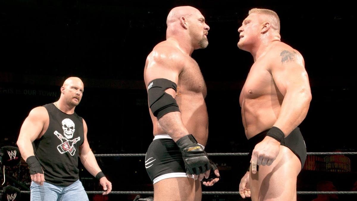 Goldberg and Brock Lesnar staring at each other as Steve Austin stands behind them at WWE WrestleMania 20