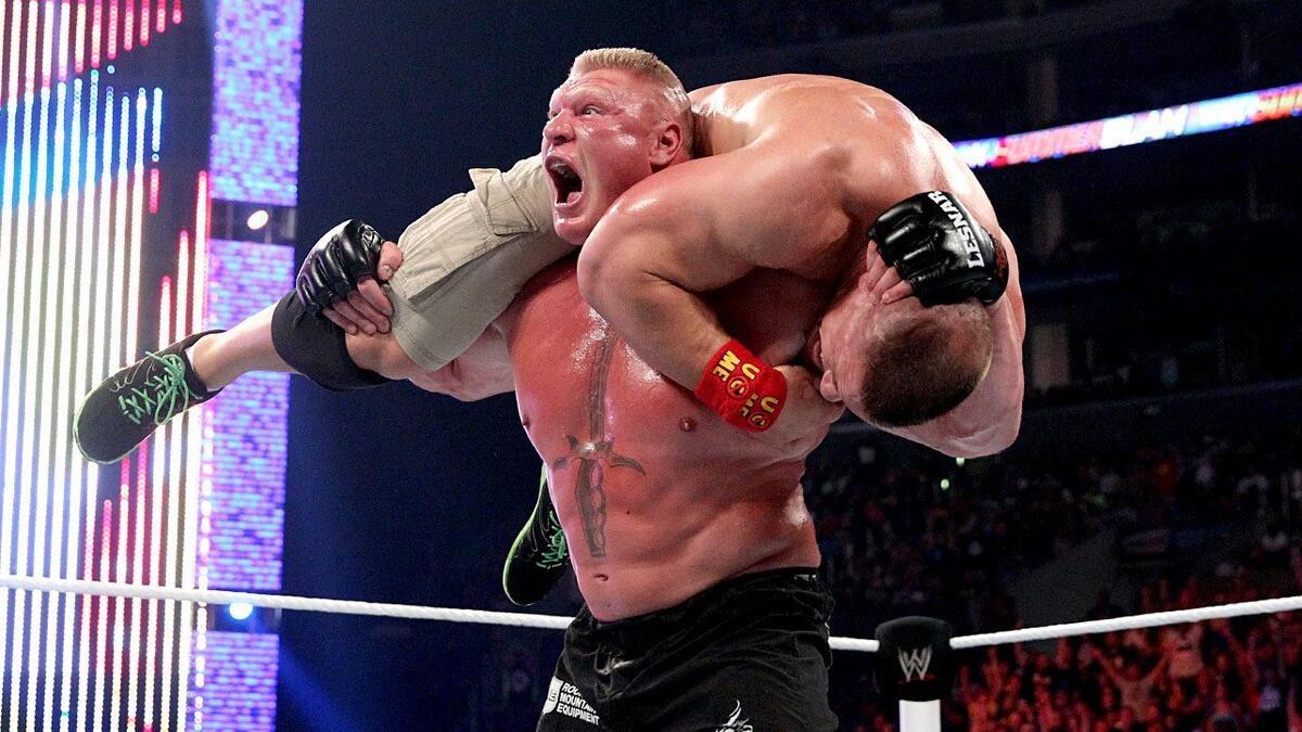 Brock Lesnar with John Cena on his shoulders at WWE SummerSlam 2014