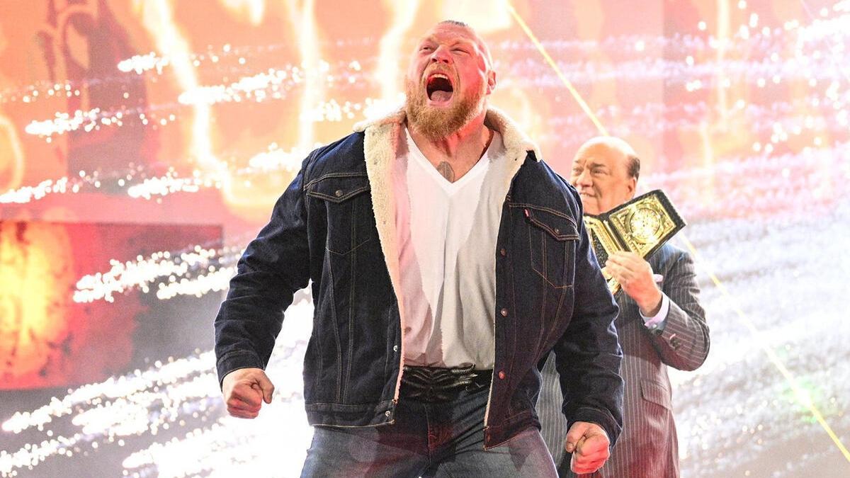 Brock Lesnar makes his entrance during an episode of Raw in 2022, with Paul Heyman accompanying him and holding the WWE Championship belt