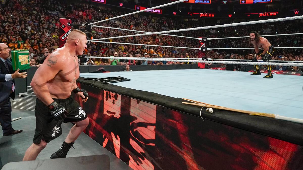 Brock Lesnar on the outside of the ring looking at Seth Rollins inside the ring at Extreme Rules 2019