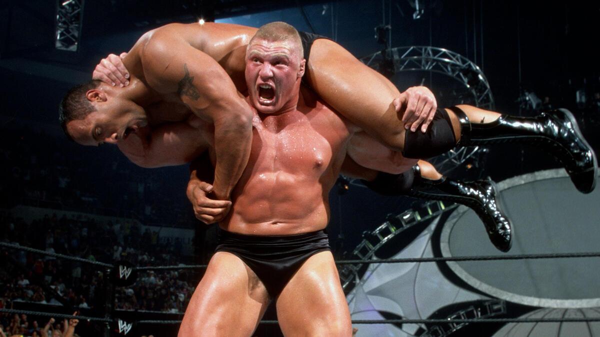 Brock Lesnar about to hit an F5 on The Rock, who is on his shoulders, at WWE SummerSlam 2002