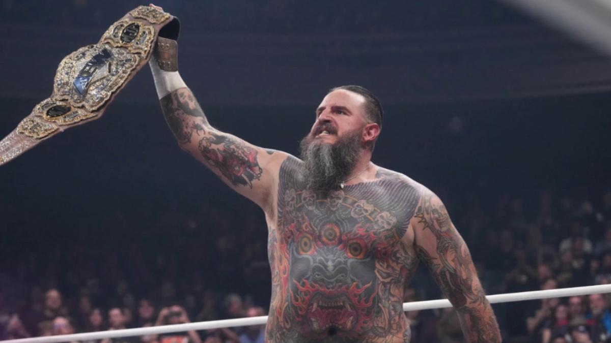 Brody King holding up the AEW World Title 