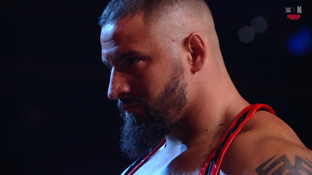 Bron Breakker staring into the distance with a black background behind him on WWE Raw
