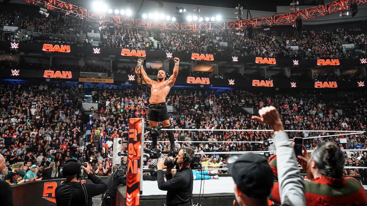 Bron Breakker on the middle turnbuckle celebrating his Intercontinental Title win with the belt in front of the crowd