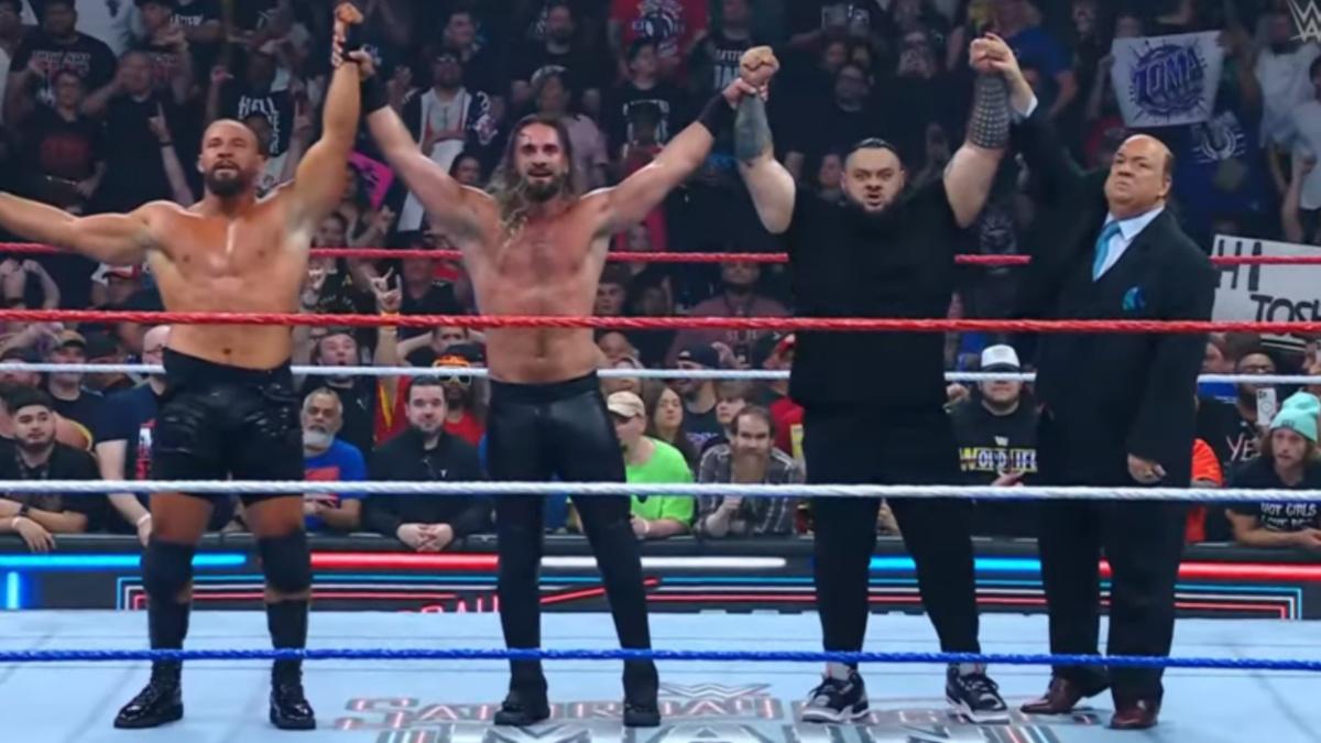 Bronson Reed, Seth Rollins and Bron Breakker holding their hands in the air together 