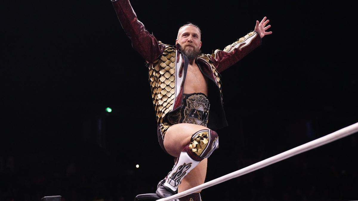 Bryan Danielson in a red dragon jacket on the turnbuckle with his arms outstretched 