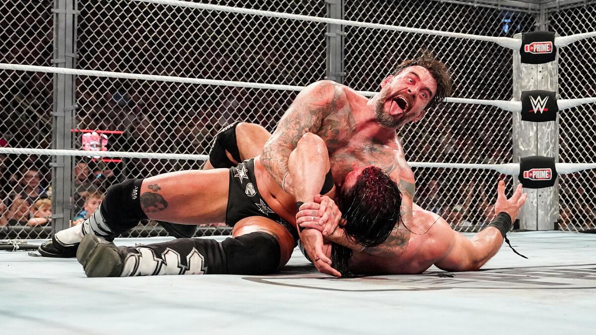 CM Punk traps Drew McIntyre in the Anaconda Vice submission hold at WWE Bad Blood 2024.