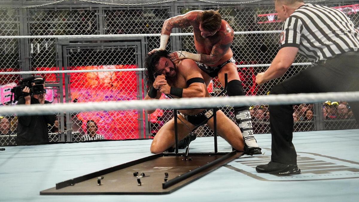 CM Punk trying to force Drew McIntyre's eye into a table leg at WWE Bad Blood 2024