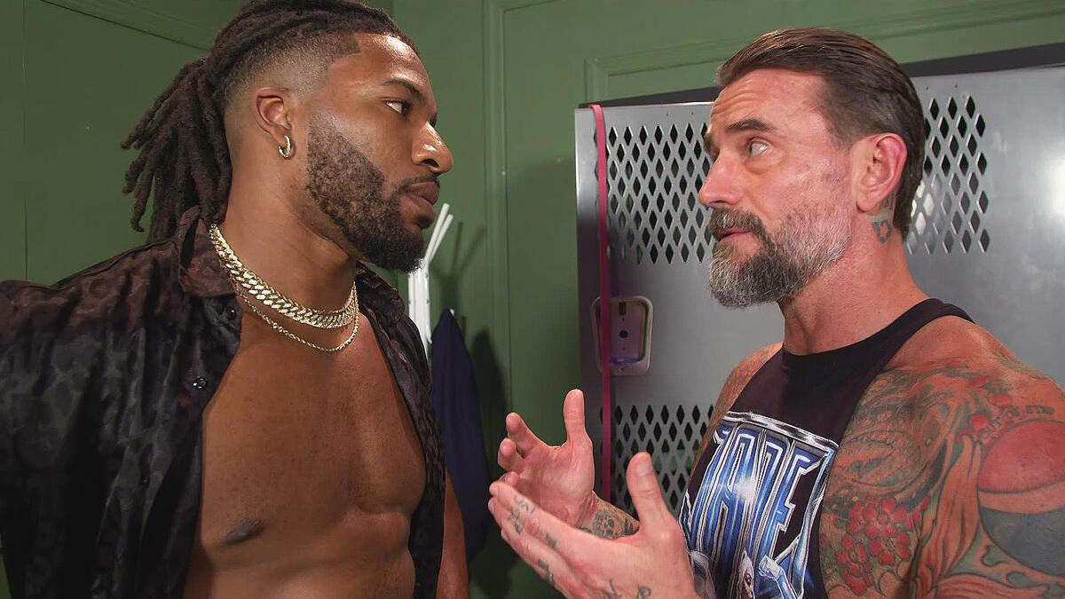 CM Punk speaking to Trick Williams backstage during a WWE NXT segment in September 2024