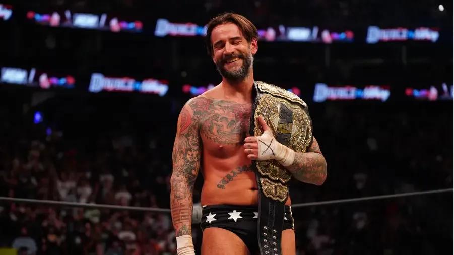 CM Punk smiling AEW world title.jpg