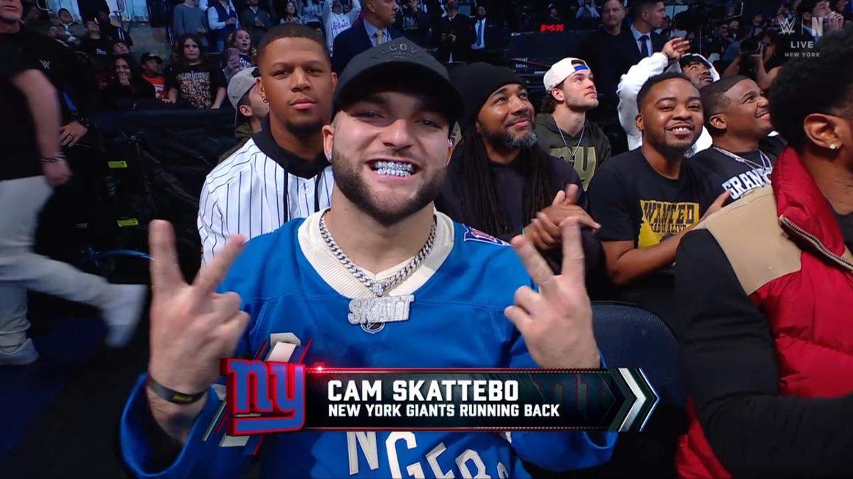 Cam Skattebo smiling while wearing a New York Rangers jersey on WWE Raw